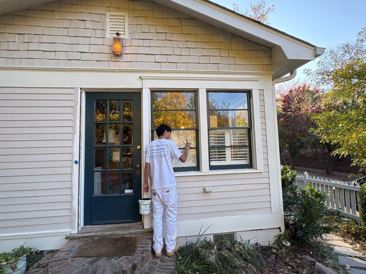 Hiring House Painters In The Spring - Atlanta's Paint Doctor team member painting the exterior of a house