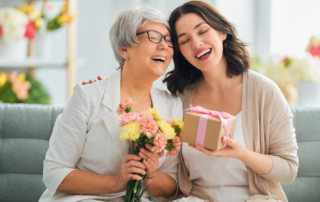Mother and daughter hugging with presents - Mother’s Day Gift Idea: A Room Makeover