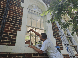 The Truth About Cheap Paint Jobs: Why Quality Matters - A painter painting window trim with care.