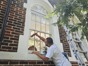 The Truth About Cheap Paint Jobs: Why Quality Matters - Painter painting window trim with care