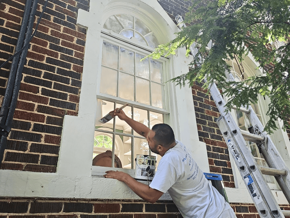 The Truth About Cheap Paint Jobs: Why Quality Matters - Painter painting window trim with care