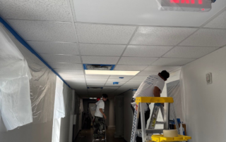 Local Regulations for School Renovations - 2 painters painting a charter school.