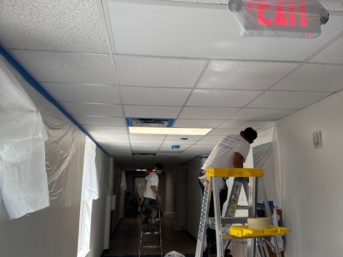Local Regulations for School Renovations - 2 painters painting a charter school.