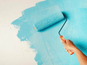 The Hidden Risks of Hiring Unlicensed or Uninsured Painters - Hand rollerpainting a wall
