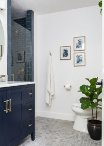 Modern bathroom with blue cabinets and SW Snowbound shade on the walls