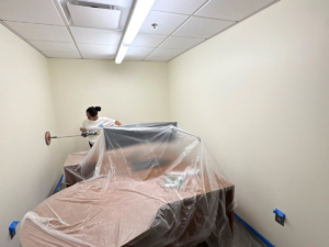 Commercial Maintenance Checklist to Start the Year Right - Commercial painter sanding office wall
