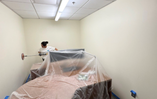 Commercial Maintenance Checklist to Start the Year Right - Commercial painter sanding office wall