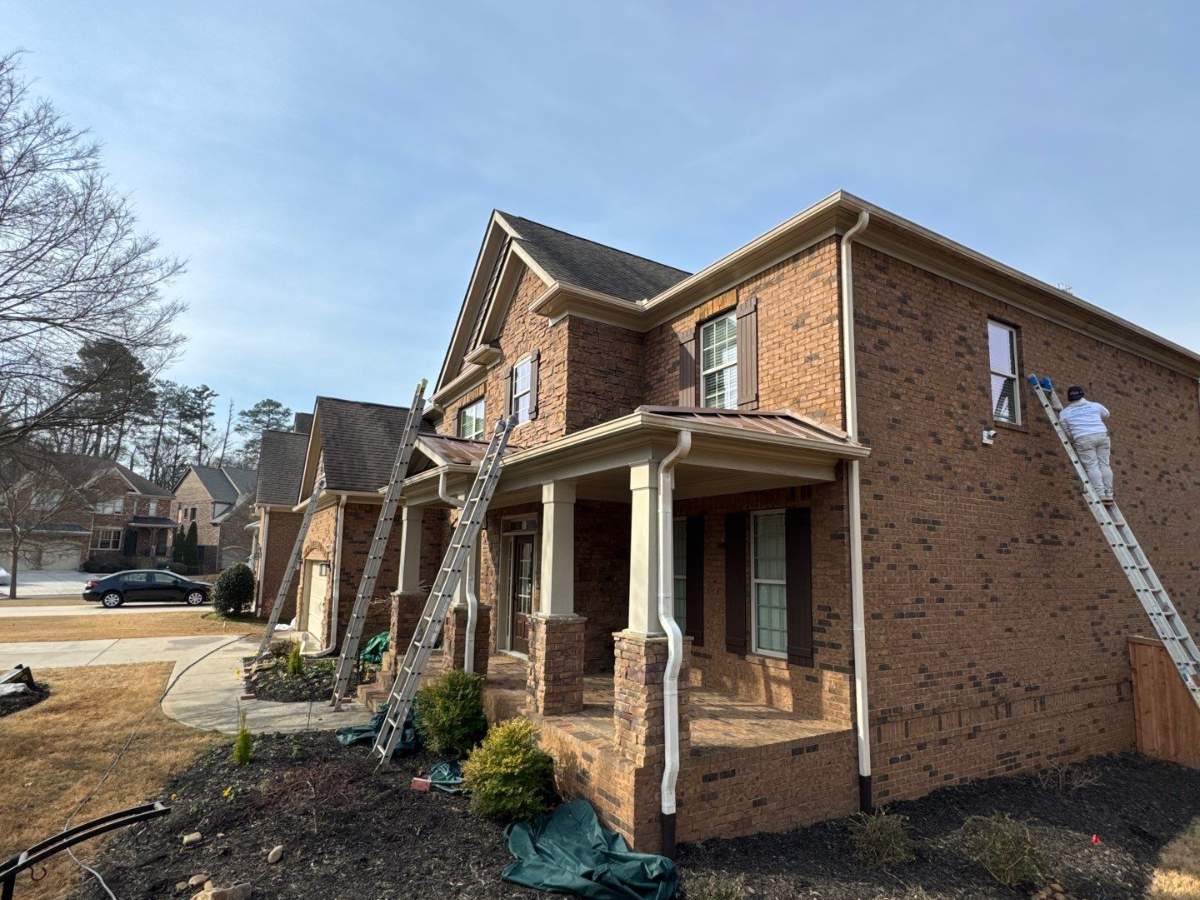 What Homeowners Often Overlook When Hiring Exterior Painters - Atlanta's ´Paint Doctor team powerwashing exterior of a house