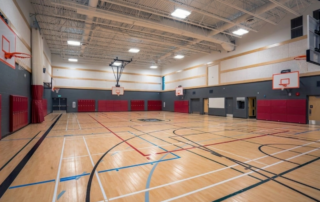 Beyond Classrooms: Painting Gyms, Hallways, and Athletic Facilities at Atlanta Schools - school gym with grey and red accents