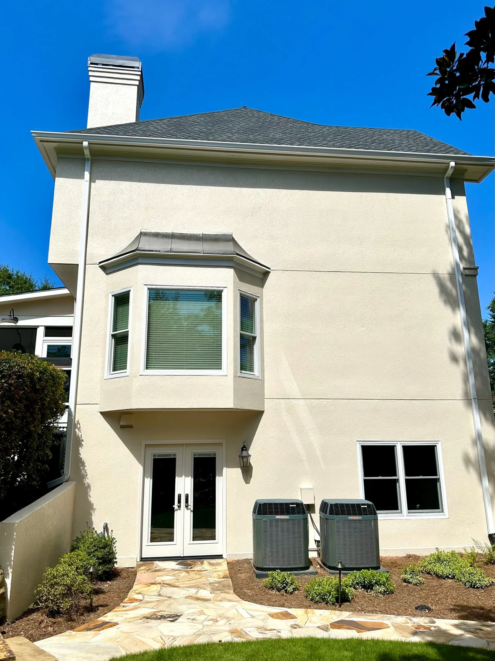 Exterior House Painting Renovation North Atlanta Rear view of a large residential home with new exterior paint in North Atlanta.