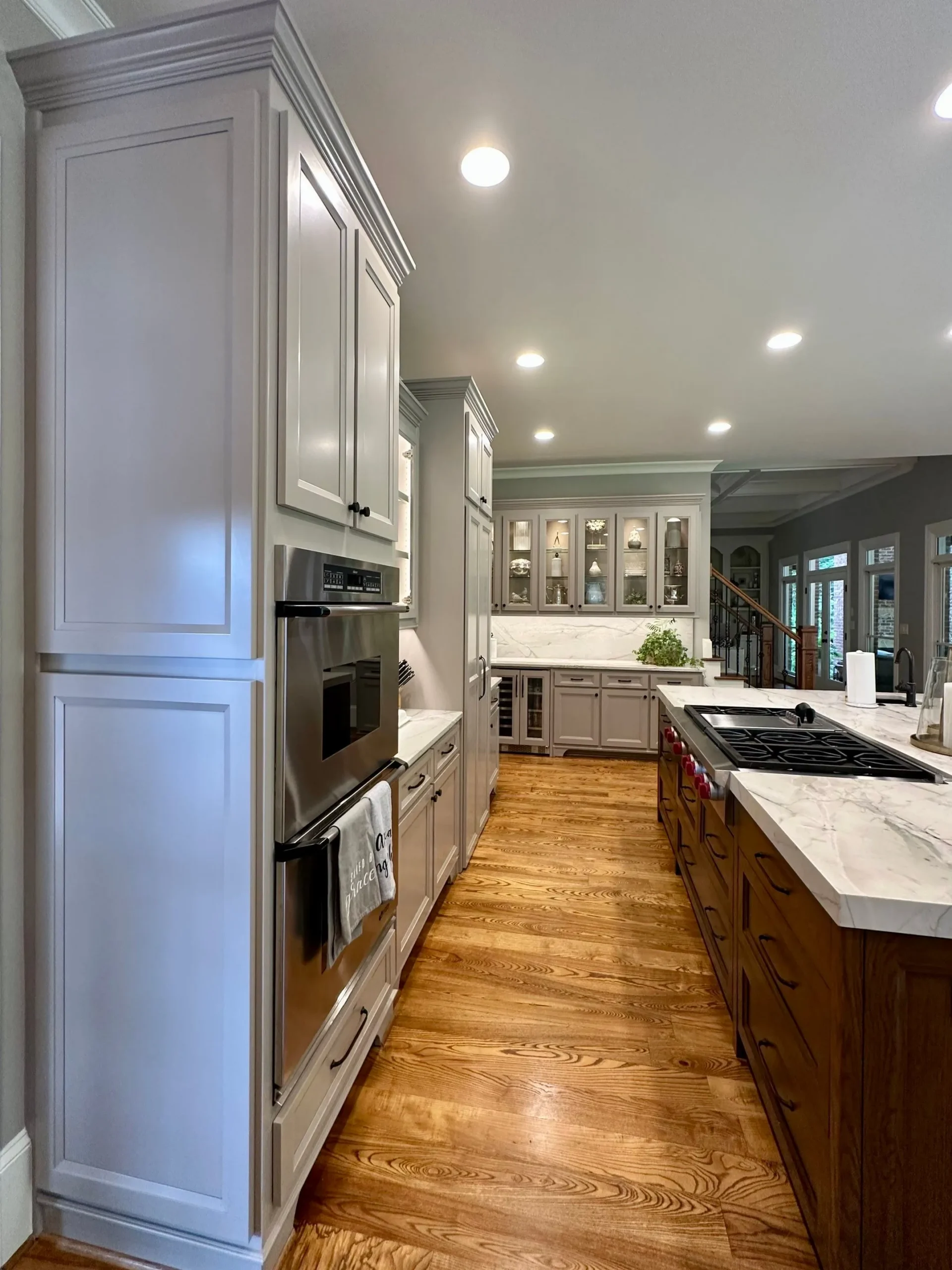 Modern Kitchen Cabinet Painting in North Atlanta Sleek painted kitchen cabinets with built-in appliances and wood floors in North Atlanta.