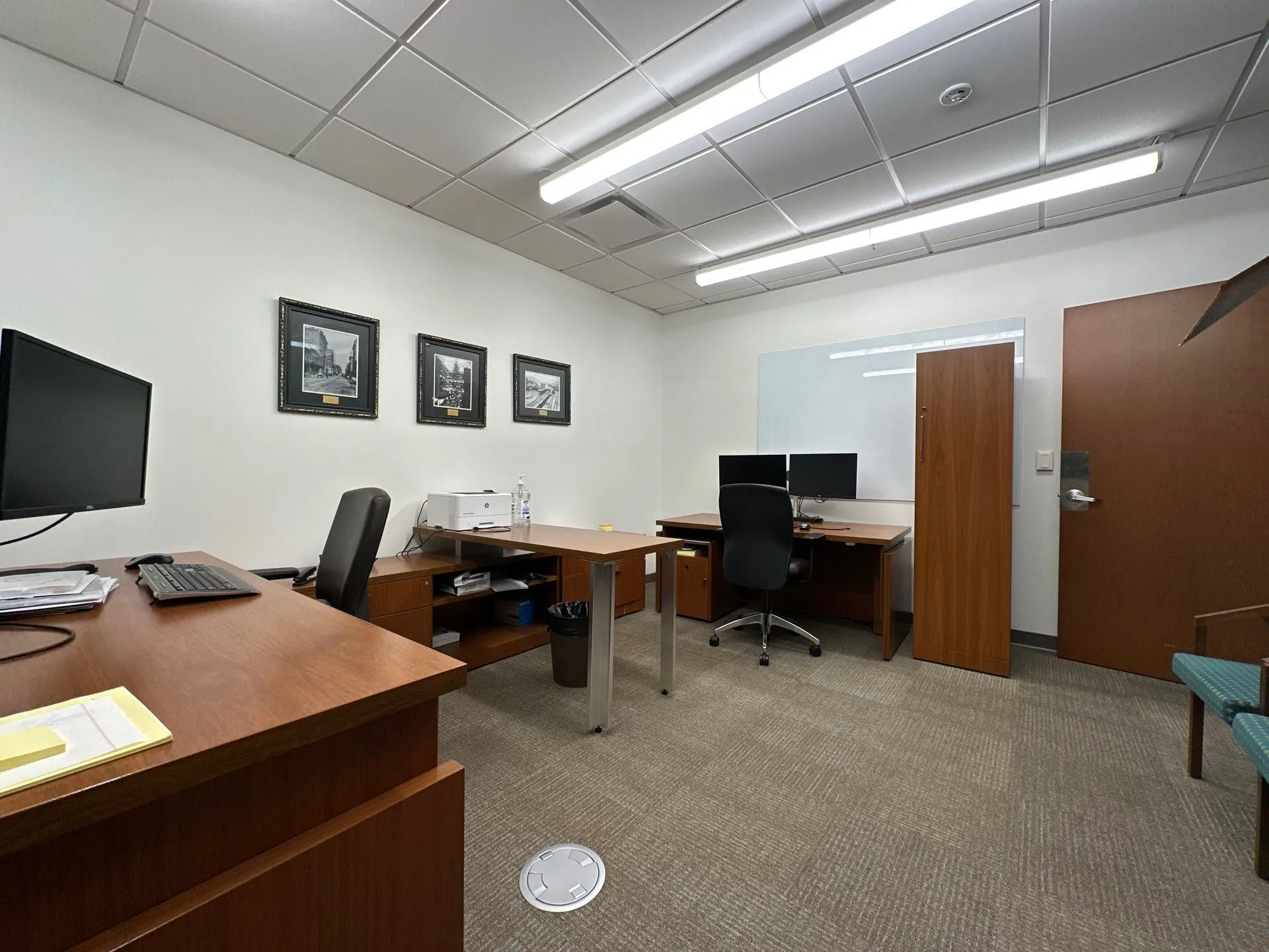 Professional Office Interior Painting in North Atlanta Well-lit office space with white walls, multiple desks, and chairs in North Atlanta.