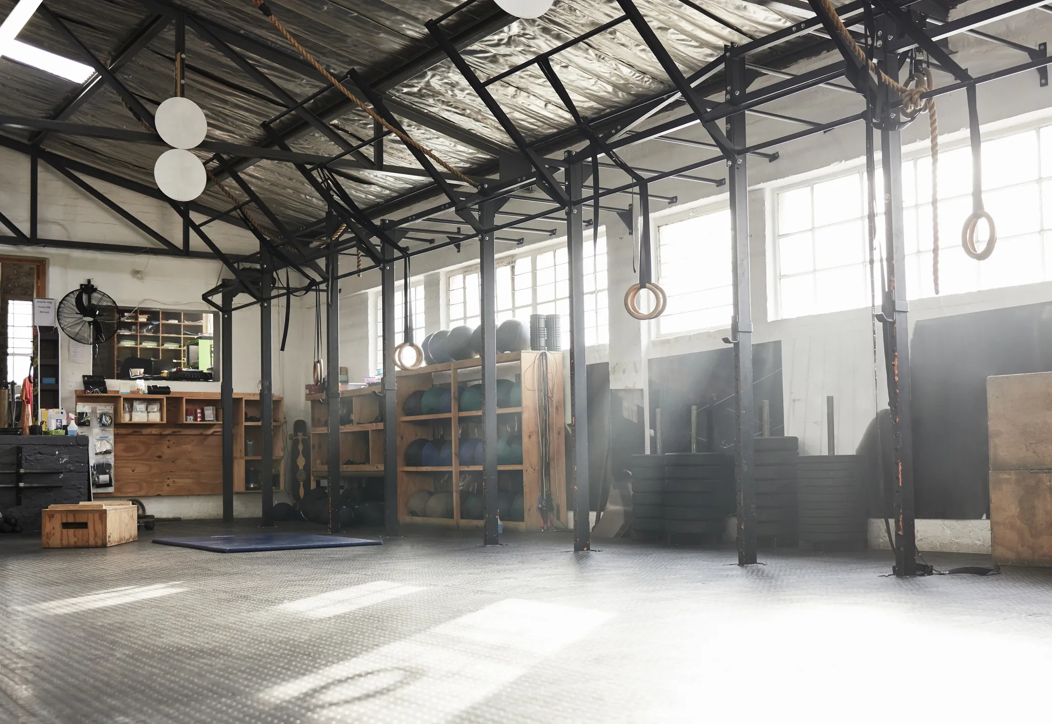 Commercial Painting for Gyms North Atlanta Spacious, empty gym interior with high ceilings and equipment, perfect for commercial painting in North Atlanta.