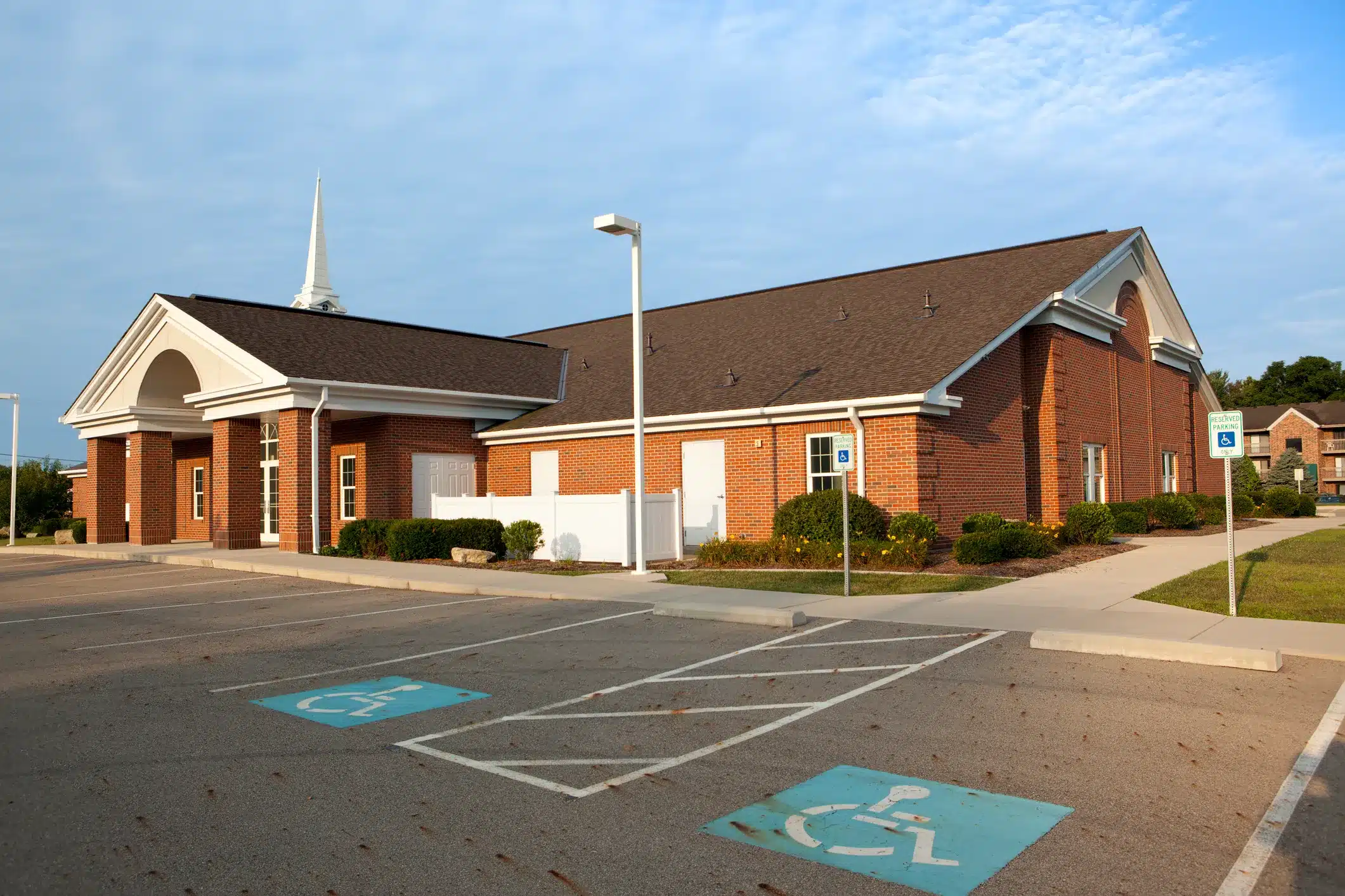 Commercial Painting for Churches North Atlanta Modern brick church building with parking lot, suitable for commercial painting in North Atlanta.